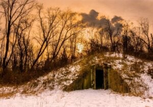 An earth-covered concrete bunker stands in the woods of the former West Virginia Ordnance Works near Point Pleasant, W.Va. Built to store explosives during World War II, the bunkers later became associated with the area's Mothman legend. (Photo by Jesse Thornton)