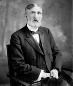 Black-and-white studio portrait of West Virginia Gov. William M. O. Dawson, seated in a dark suit with a bow tie and a full white beard.