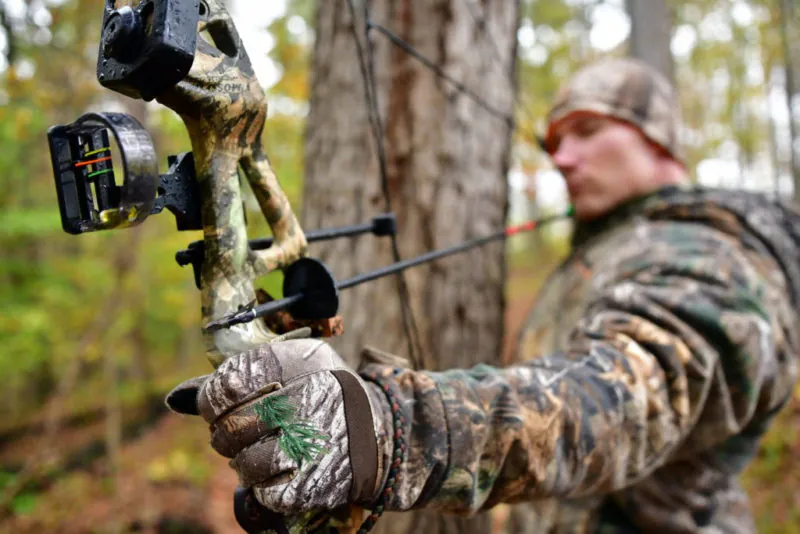 An archer in the West Virginia forest draws his bow. Photo courtesy W.Va. Dept. of Commerce.