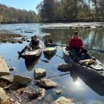 Members of the Trash-Your-Kayak Cleanup Crew paddle at a launch on a West Virginia stream.